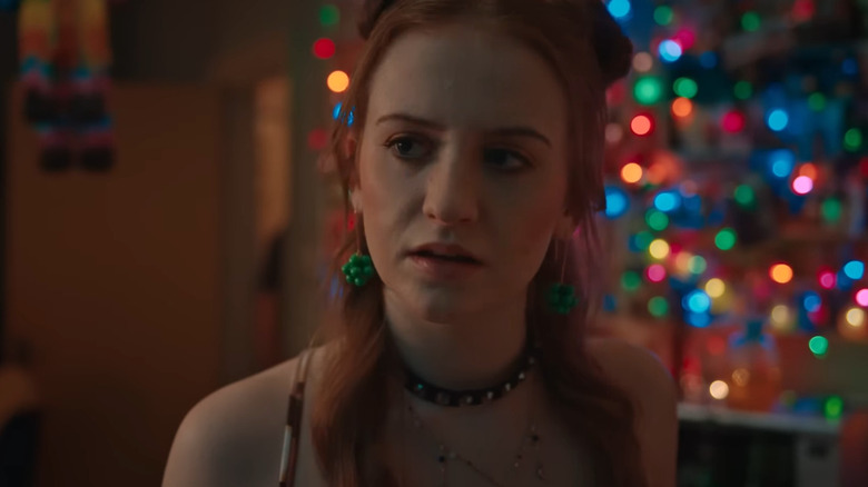 Jen with rainbow ligths behind her in Extraordinary