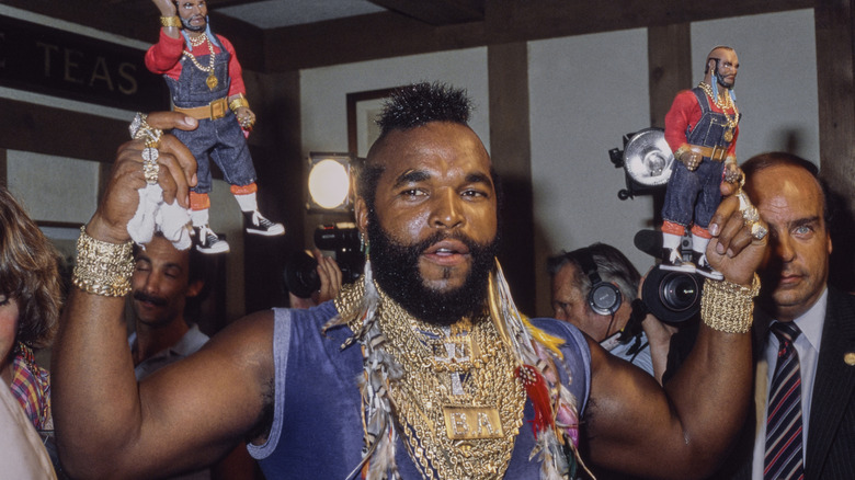 Mr. T holding his own action figures in the 1980s