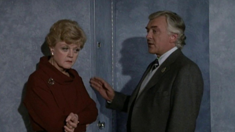 Jessica Fletcher stands outside an airplane bathroom in "Murder, She Wrote"