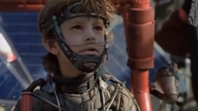 a child wearing a uniform that's very similar to Dune stillsuits in Earth 2