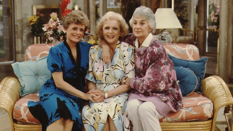 The cast of The Golden Girls poses together on the couch.