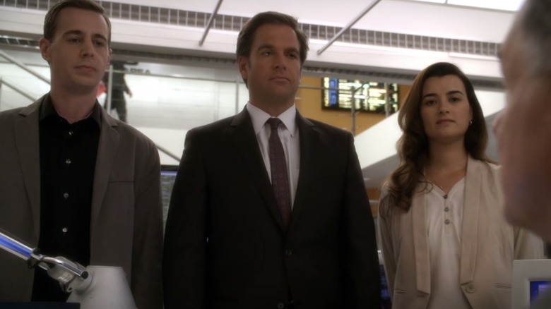 Agents Timothy McGee, Tony DiNozzo, and Ziva David staring down Gibbs