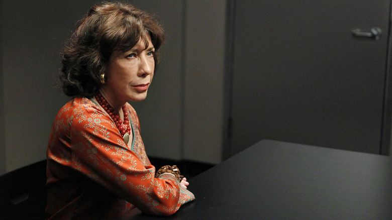 Lily Tomlin as Penny sitting in an interrogation room in NCIS