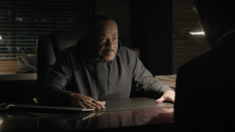 Director Vance speaks to someone over his desk in an NCIS episode.