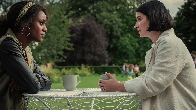 Louise and Adele sit in a garden.