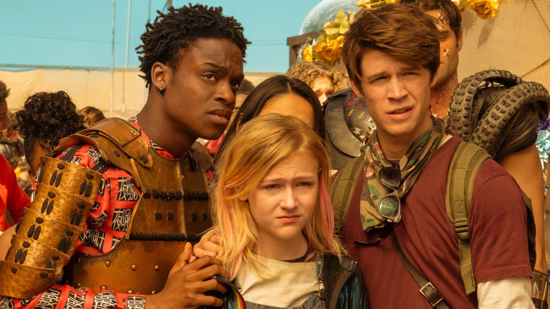 Josh Wheeler, Samaira Dean and Wesley Fists stand in front of a group of survivors.