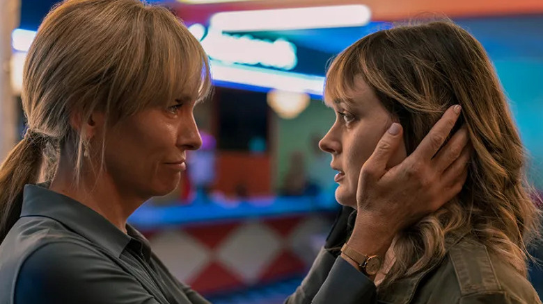 Laura Oliver grabs daughter Andy's face.