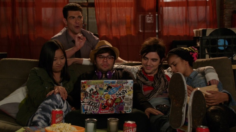 Schmidt sits behind an annoyed couch full of youths