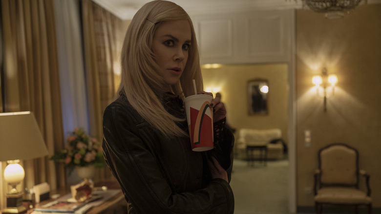 Masha (Nicole Kidman) holding a McDonald's cup and looking over her shoulder in Nine Perfect Strangers