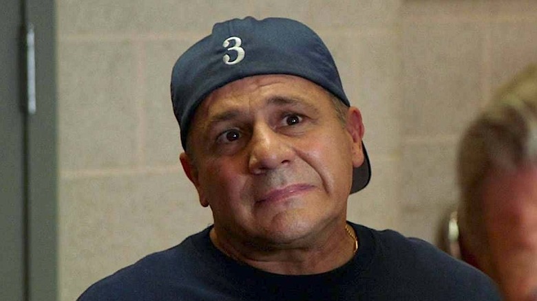 Tony wearing a navy blue shirt and backwards cap with the number 3 on it in Chicago Fire