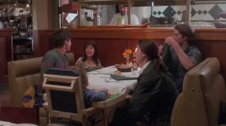 Bailey, Claudia, Owen, Julia, and Charlie sitting at a restaurant table on Party of Five