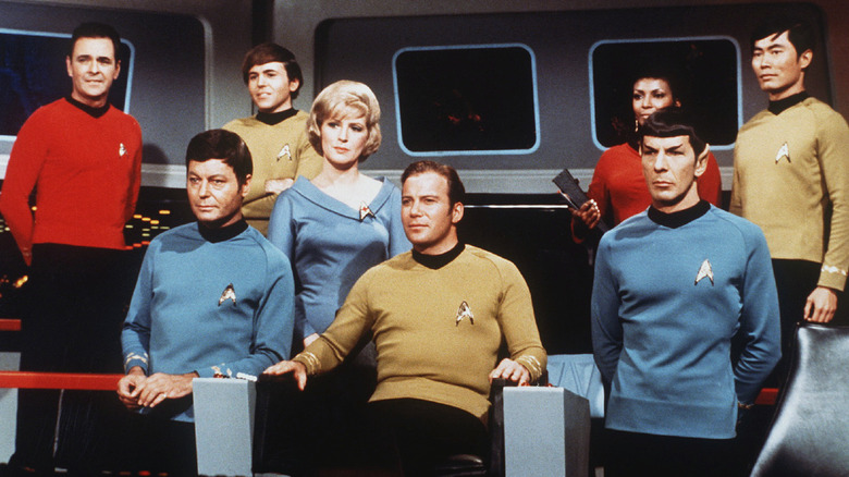 Leonard Nimoy and the cast of "Star Trek" standing on the Enterprise bridge
