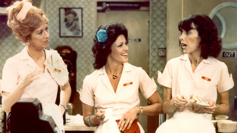 The three waitresses of Mel's Diner on CBS's Alice stand and chat together.