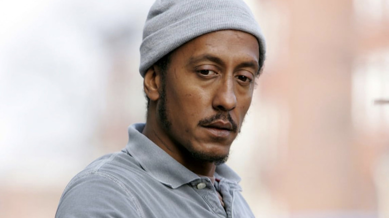 Bubbles wearing a grey shirt and a grey beanie in "The Wire"