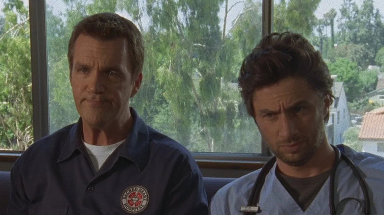 Janitor (Neil Flynn) sitting next to JD (Zach Braff) on "Scrubs."