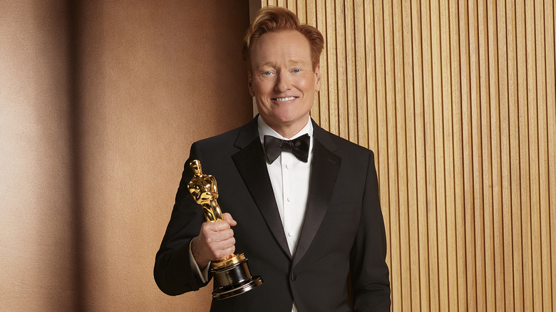 Conan O'Brien holding a 2026 Oscars trophy
