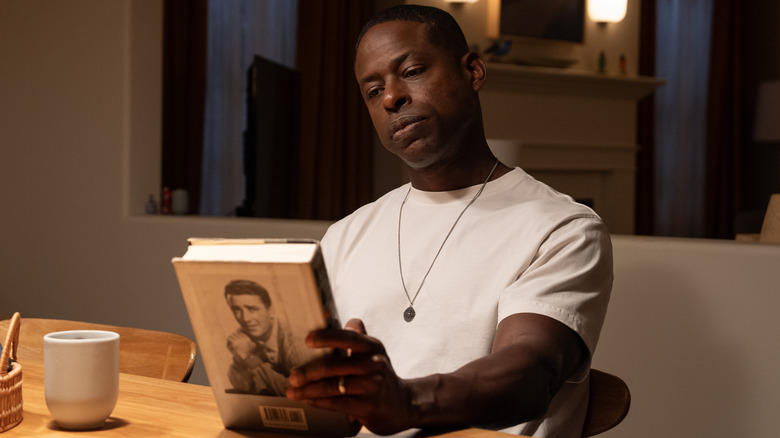 Sterling K. Brown as Xavier looks at a book in Paradise