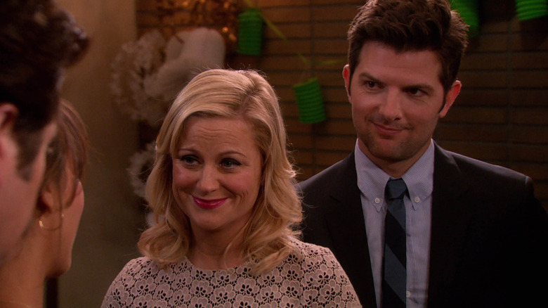 Amy Poehler as Leslie Knope and Adam Scott as Ben Wyatt smiling together in Parks and Recreation