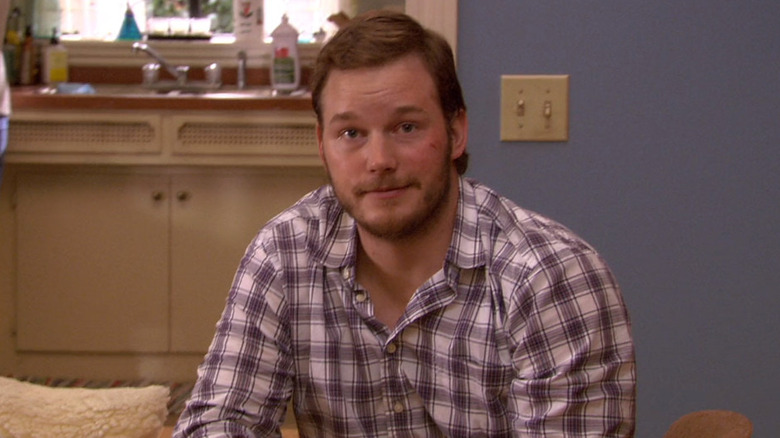 Chris Pratt as Andy Dwyer smiling at the camera in Parks and Recreation