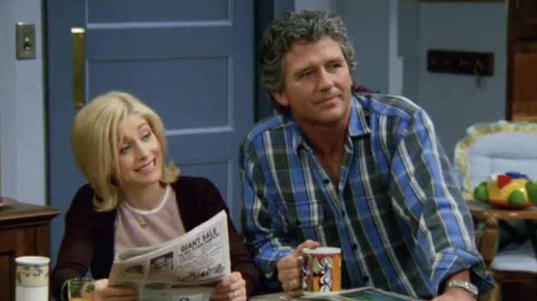 Dana Foster and Frank Lambert sitting next to each other at the kitchen table looking at another family member with skeptical faces