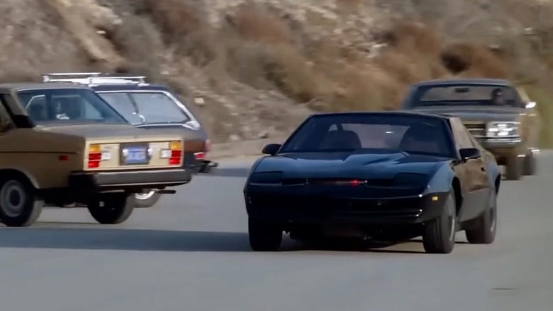 K.A.R.R. speeding down a road as other cars get out of the way