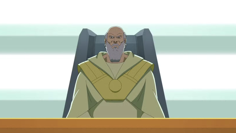Thaedus wearing a yellow tunic with a golden metal chest plate, sitting in a large gray seat