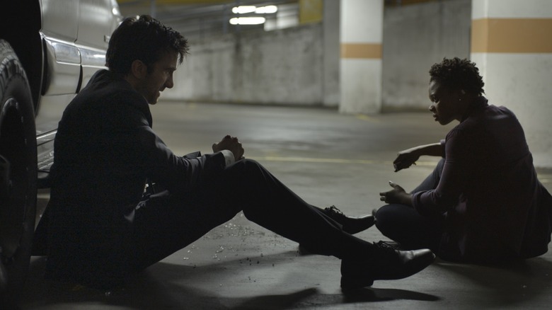 Christian Walker and Deena Pilgrim of the Powers Division sit down for a tense talk in a parking lot on PlayStation Network's Powers.