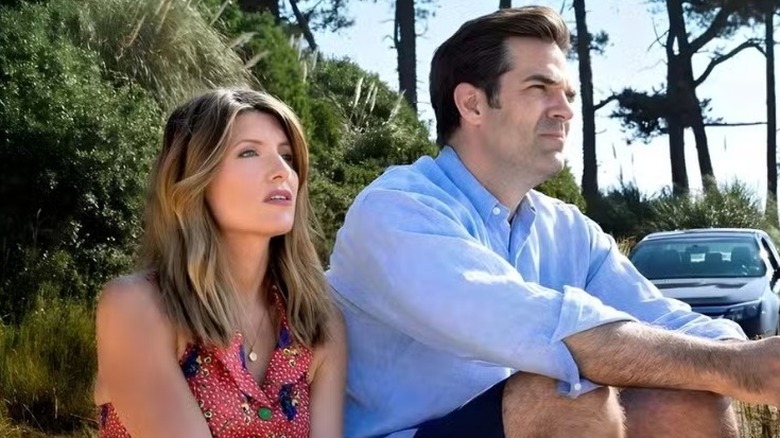 Sharon Morris sitting outside next to Rob Norris as they both look out into the distance