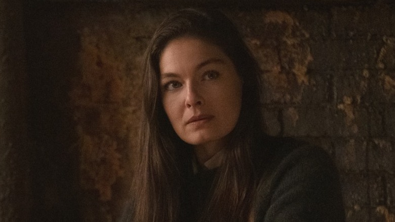 Juliana Crain looking serious in front of a brick wall in The Man in the High Castle