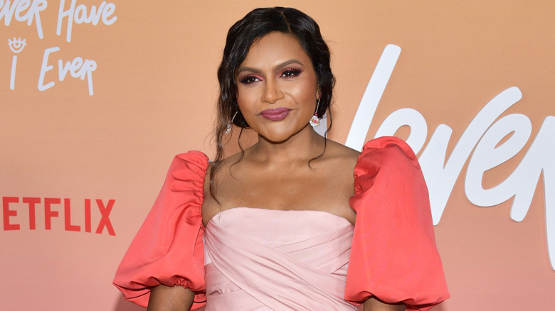 Mindy Kaling in a pink dress with puffy sleeves at the Los Angeles premiere of Netflix's "Never Have I Ever" Season 3 at Westwood Village Theater on August 11, 2022 in Los Angeles, California.