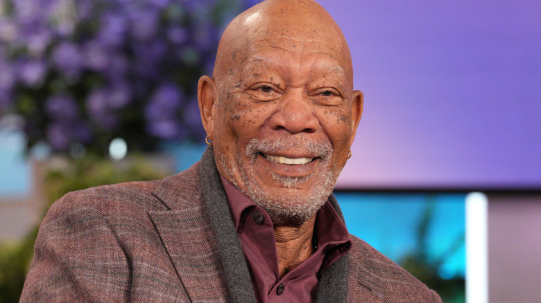 Morgan Freeman smiling in a purple suit during his guest appearance on "The Jennifer Hudson Show" on November 3, 2025.