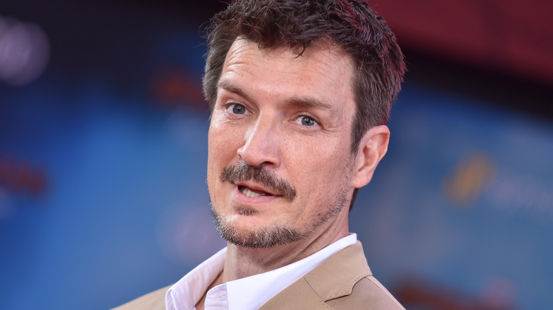 Nathan Fillion with short dark hair, a mustache, and a short beard.