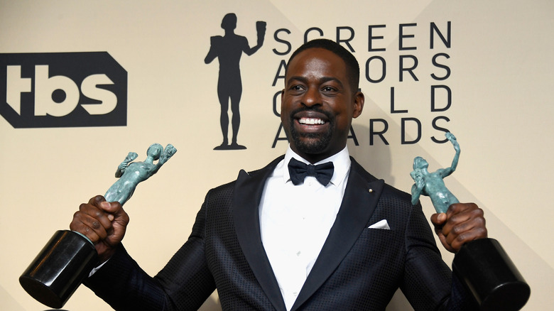 Sterling K. Brown poses in the press room holding a SAG award in each hand during the 24th Annual Screen Actors Guild Awards at The Shrine Auditorium on January 21, 2018 in Los Angeles, California.