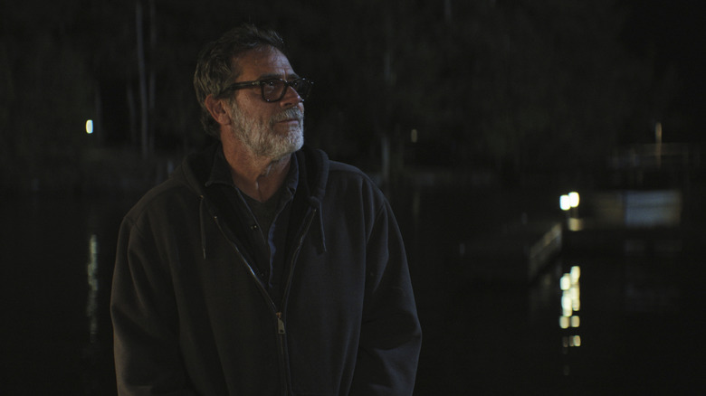 Joe wearing a black jacket and standing on a dock