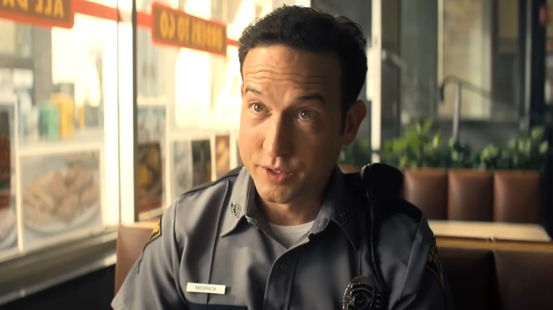 Jacob talking in restaurant booth on "Reacher"