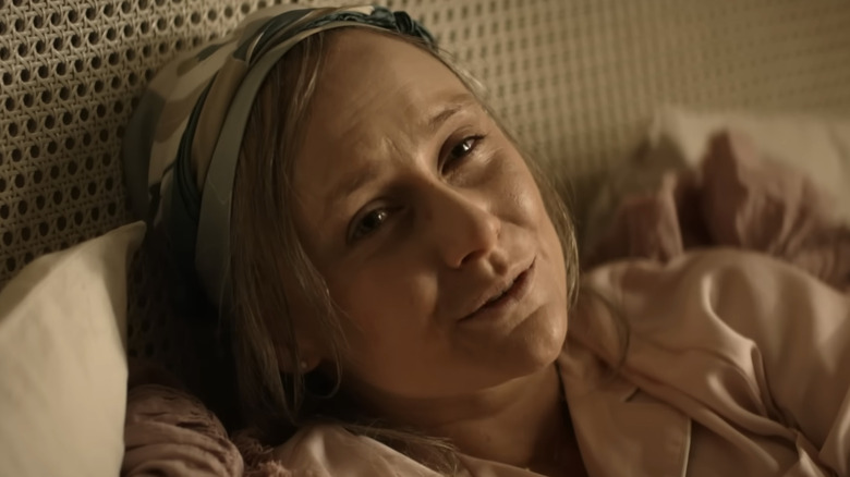 Josephine lies in bed in in "Reacher" (2022)