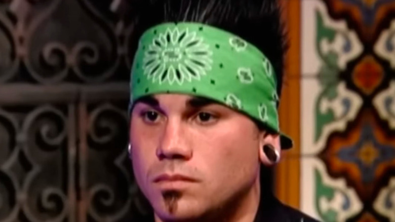 Man with spiky black hair and green bandana on Tool Academy