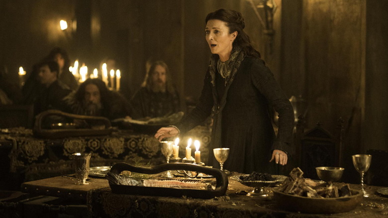 Catelyn Stark (Michelle Fairley) stands in front of a table at a wedding in "Game of Thrones"