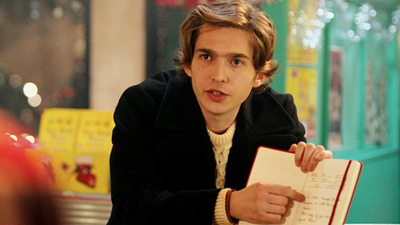 Austin Abrams as Dash pointing to notebook in 'Dash & Lily'