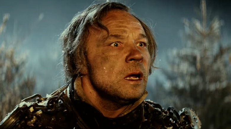 Jacob Marley covered in chains in a wintery forest in "A Christmas Carol."