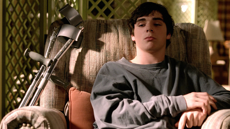 Walter Jr. (RJ Mitte) sitting down on a chair in Breaking Bad