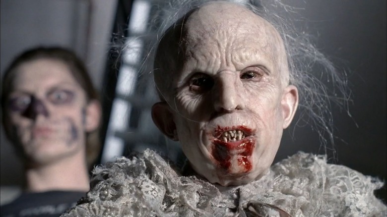 Evan Peters' Tate Langdon in skull makeup and Benjamin Woolf's Infantata with a bloody mouth on American Horror Story