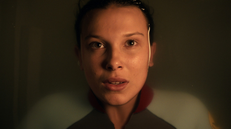 Eleven (Millie Bobby Brown) submerges in a liquid in Stranger Things