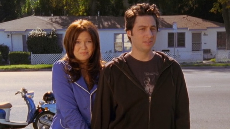 Julie Quinn (Mandy Moore) and J.D. Dorian (Zach Braff) standing together outside in Scrubs