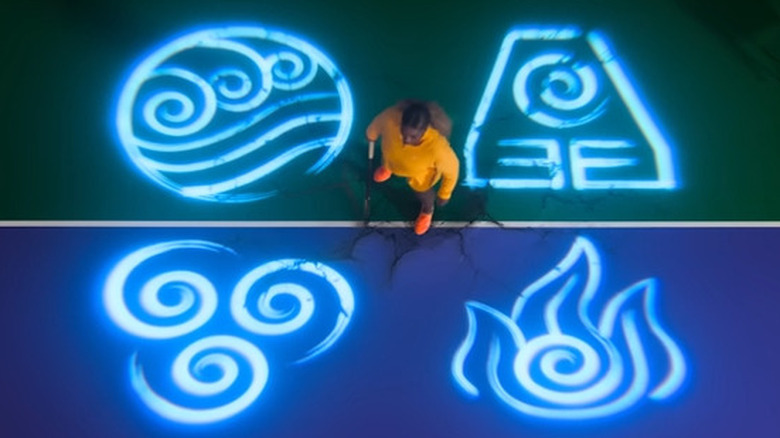 Serena Williams surrounded by the symbols of the four nations in a commercial for Netflix's Avatar: The Last Airbender