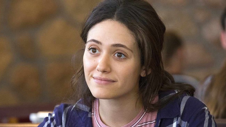 Emmy Rossum as Fiona Gallagher sitting in a restaurant in Shameless