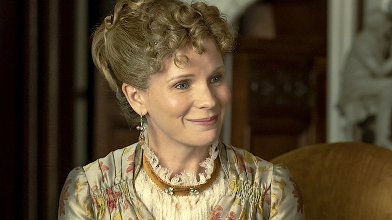 Aurora Fane in a flowery dress and smiling