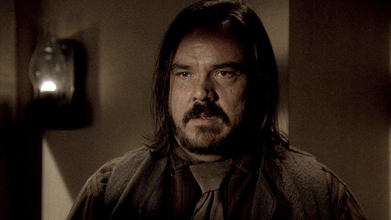 Dan Dority standing in a brown shirt in Deadwood