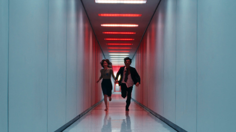 Helly R and Mark S running down testing floor hallway towards camera