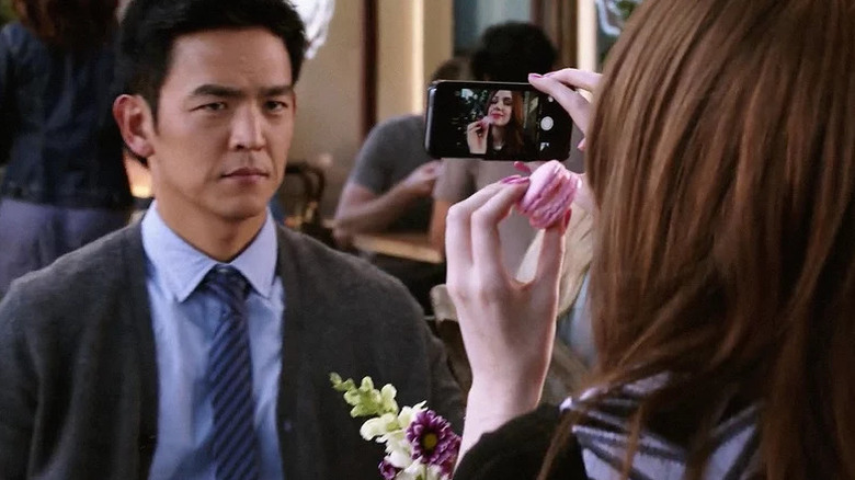 Henry Higgs watches Eliza Dooley take a selfie in Selfie
